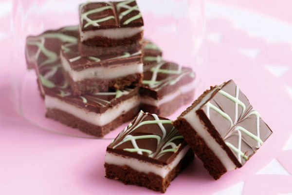 Chocolate Peppermint Slice - These slices are renowned for being the ultimate indulgence. Three layers, each more scrumptious than the last. You cannot describe the taste of these delights but once you try one you’ll be under their spell forever!
